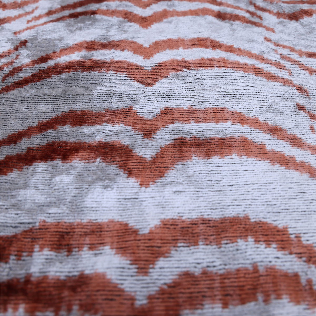 Silver gray and terracotta rust chevron pattern with visible velvet pile