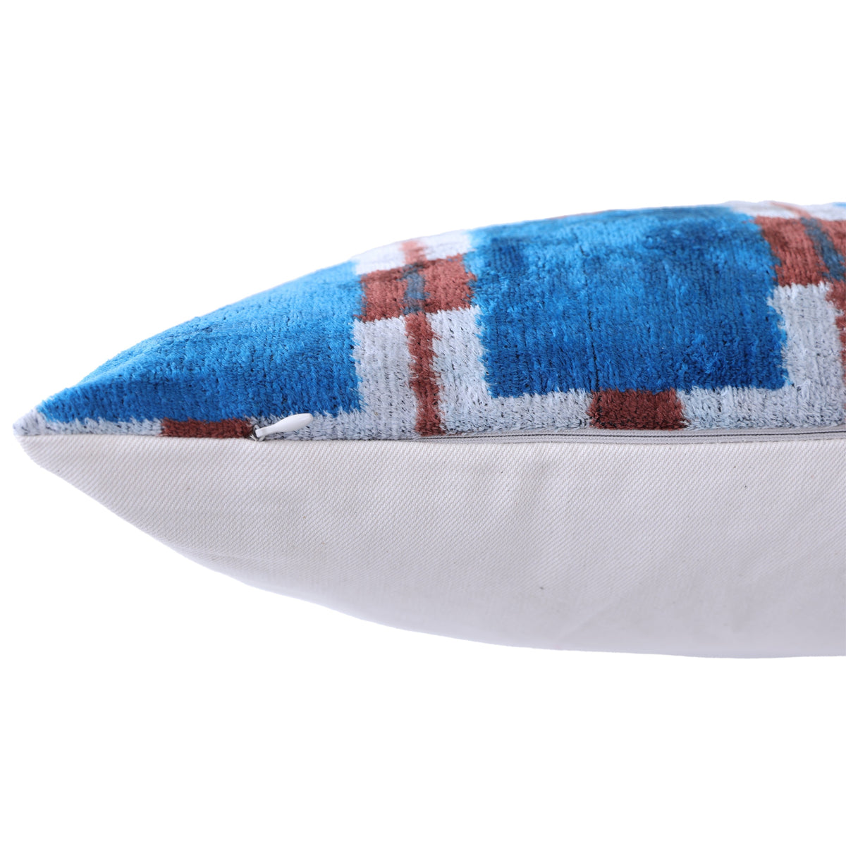 Close-up of the edge seam and hidden zipper on a cobalt blue plaid lumbar pillow