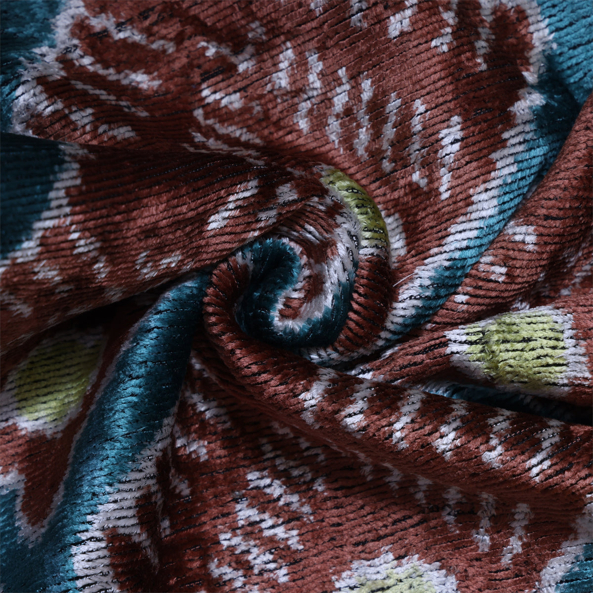Close-up of terracotta rust and deep teal blue plush cut-pile velvet with ribbed texture