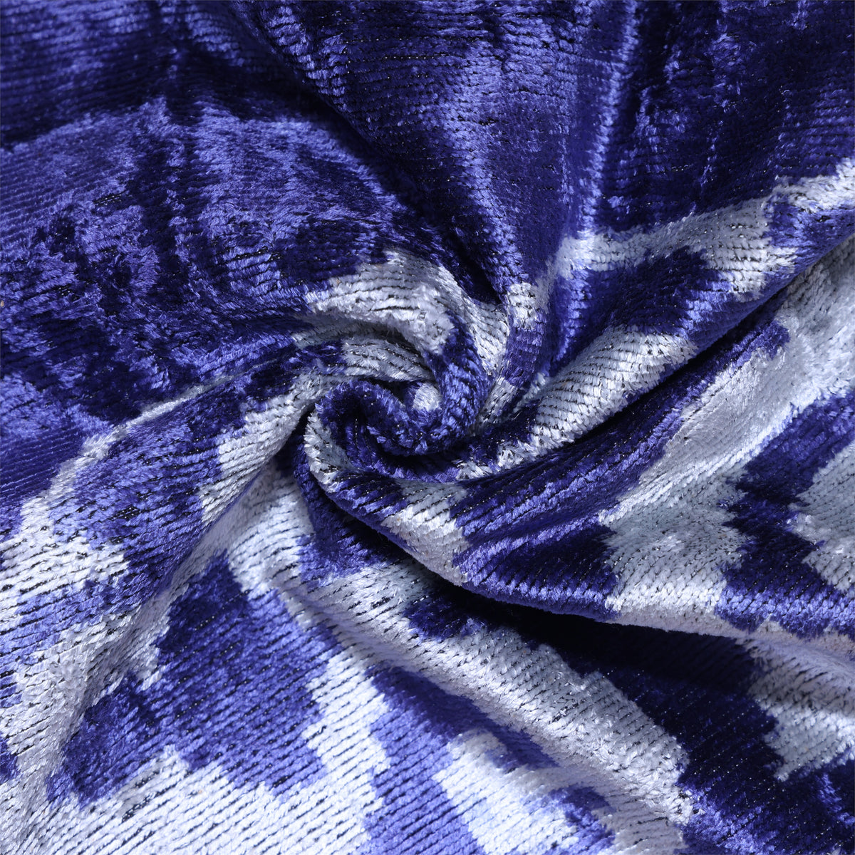 Close-up of cobalt blue and silvery light gray gathered velvet with ikat pattern