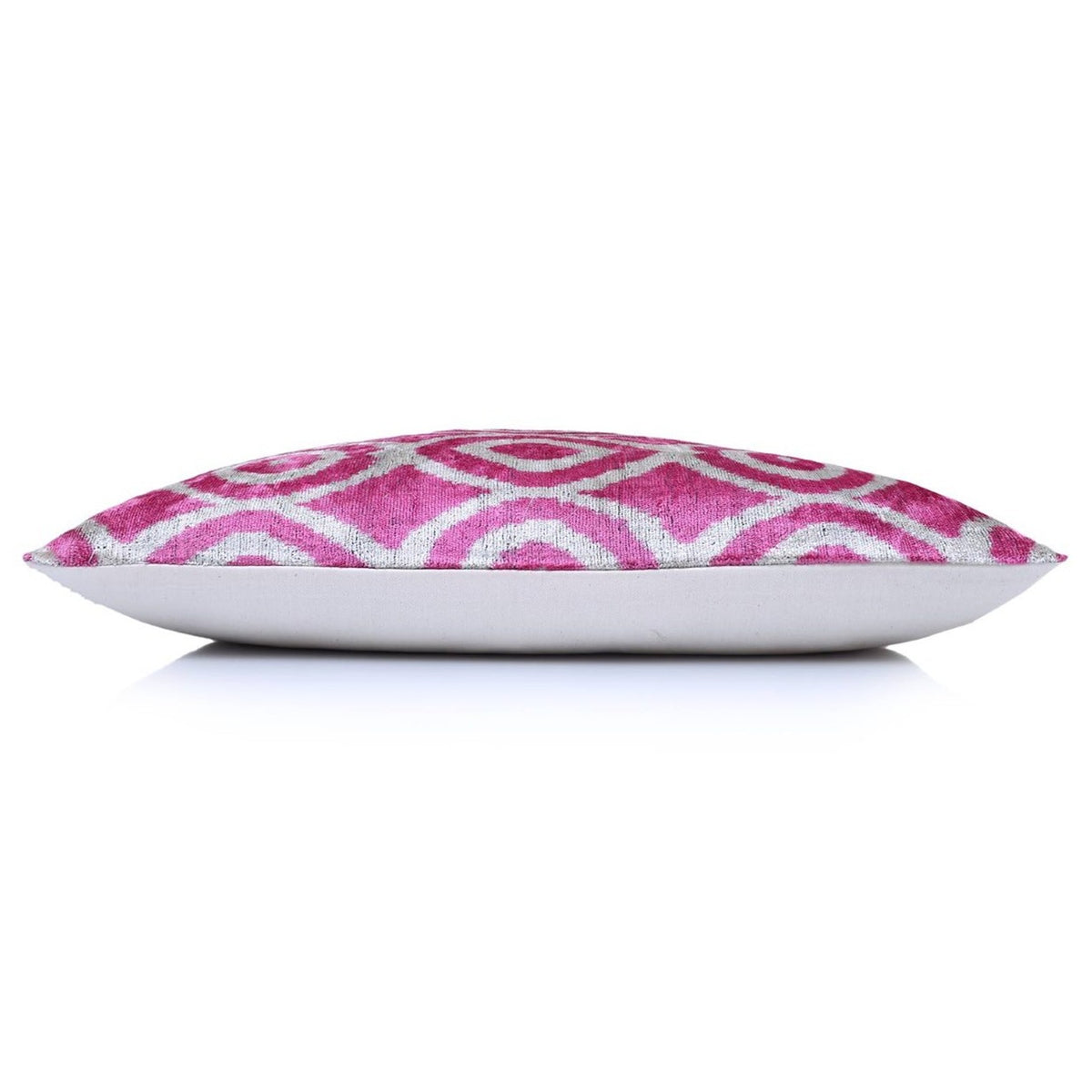 Top edge view of fuchsia pink and silvery white lumbar cushion with solid backing