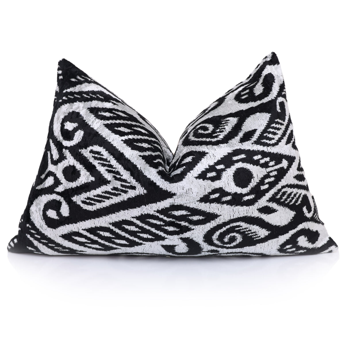 Silvery white and jet black ikat lumbar pillow styled with chop arrangement