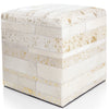 Cube-shaped ottoman with a textured white and gold pattern on a white background