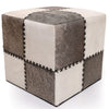 Cube-shaped ottoman with a patchwork design in beige, brown, and gray on a white background.