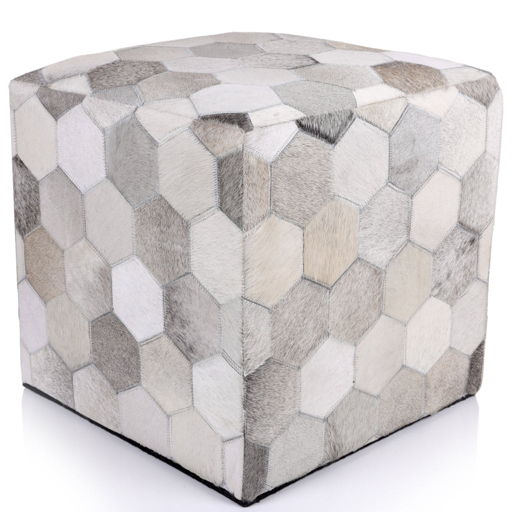 Cube-shaped ottoman with hexagonal patchwork pattern on a white background