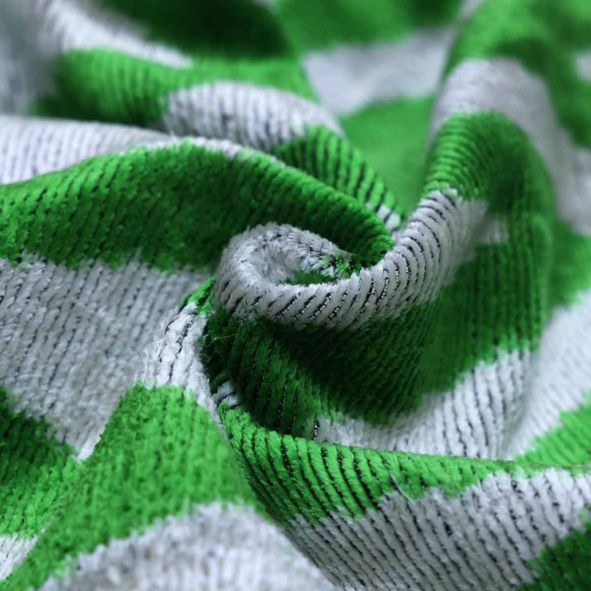 Angled detail of textured bright green and light gray chevron velvet