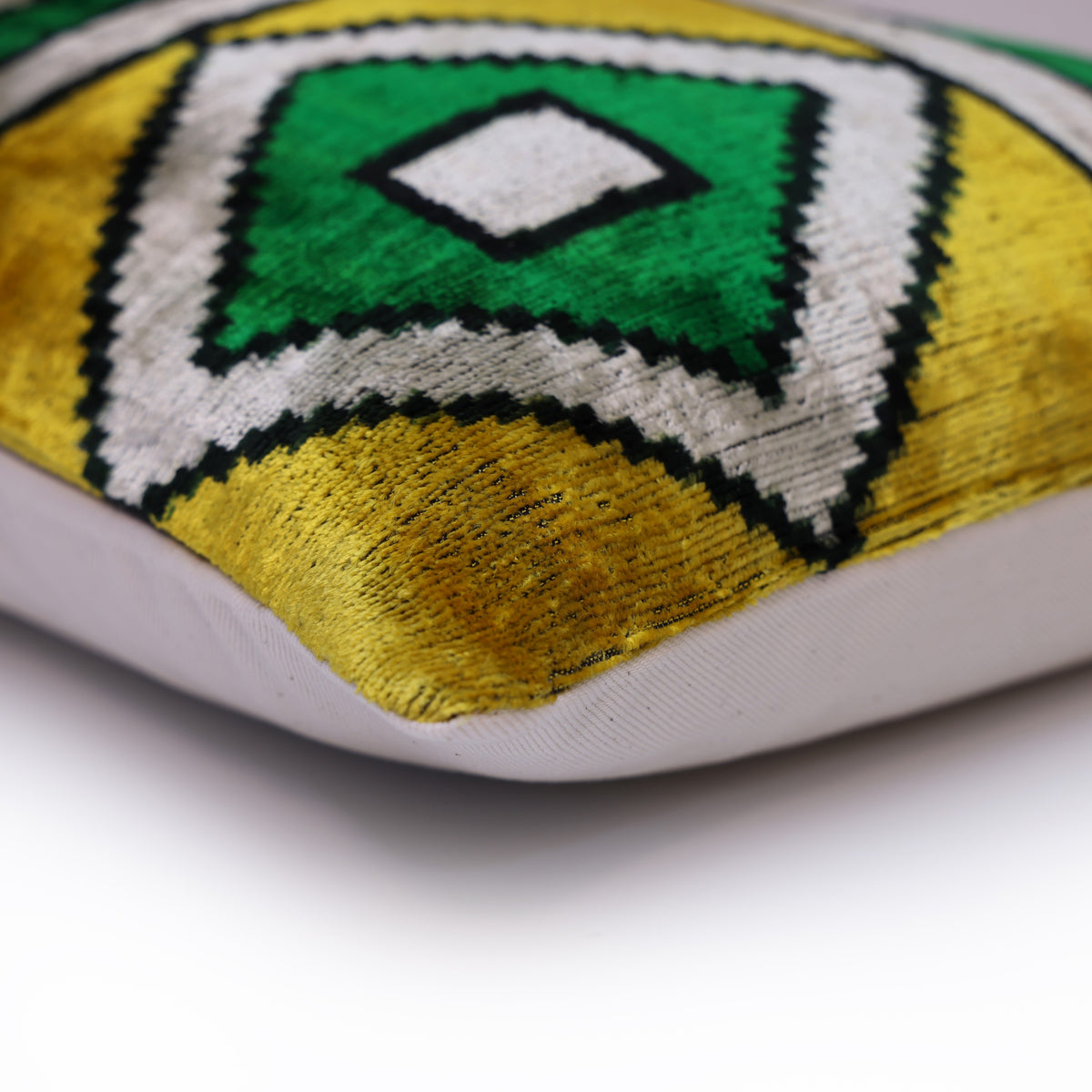 Corner detail showing the geometric velvet front joined to the pale backing seam