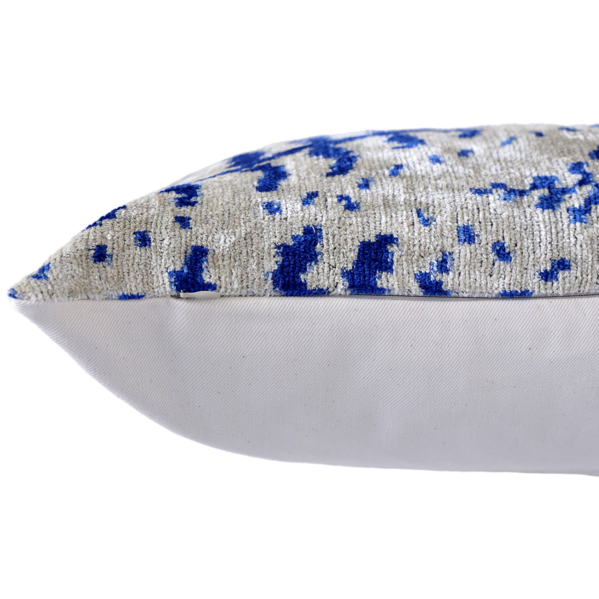Side edge of lumbar pillow showing seam and hidden zipper closure