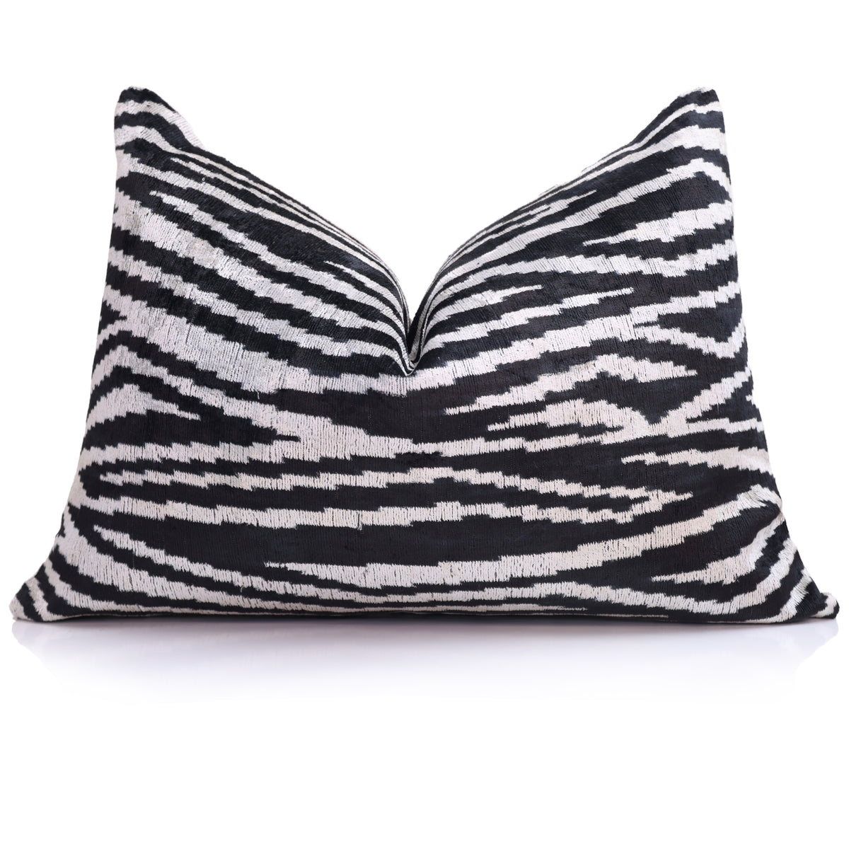 Black and ivory zebra lumbar pillow styled with a centered chop on a sofa
