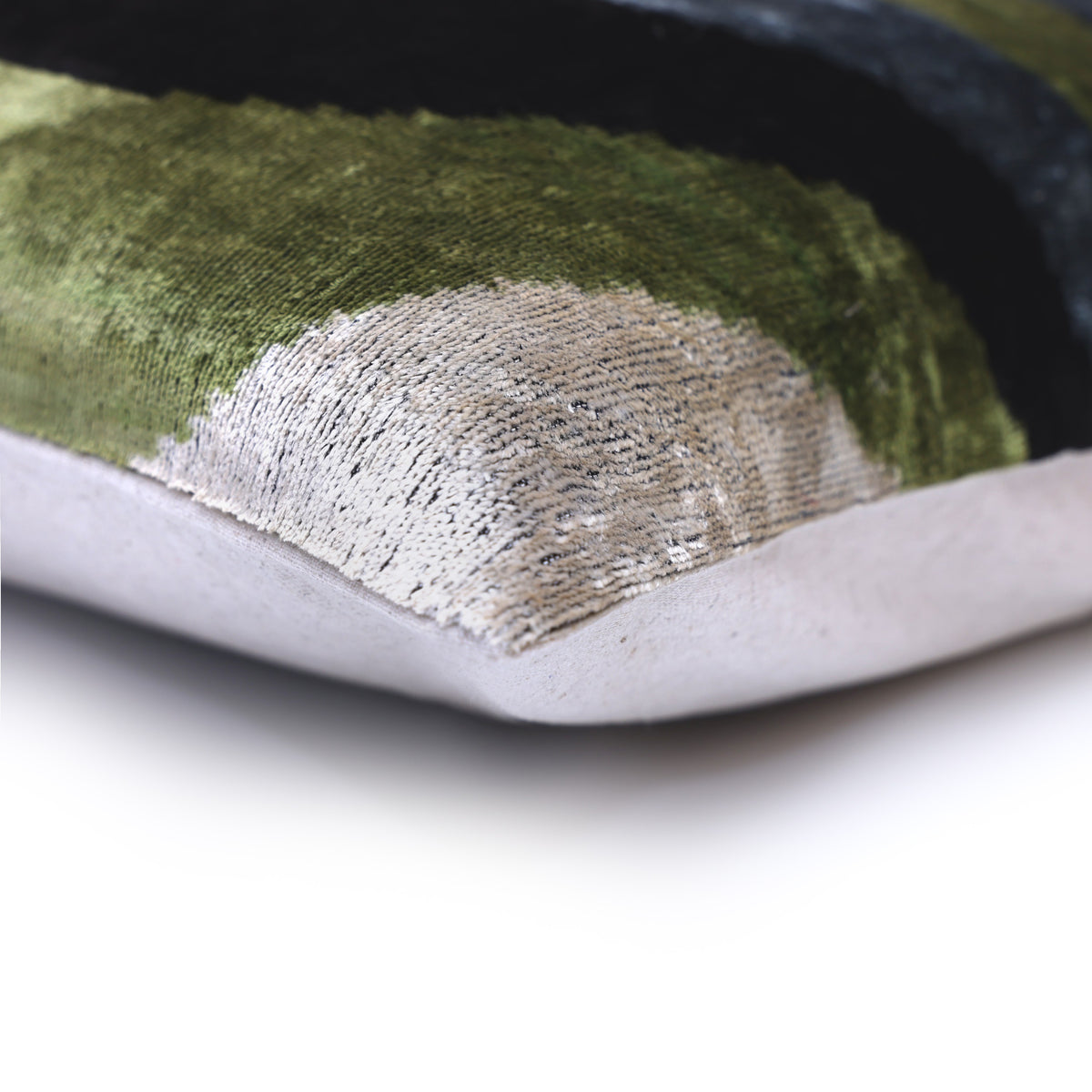 Pillow corner showing plush velvet edge and its light linen backing seam