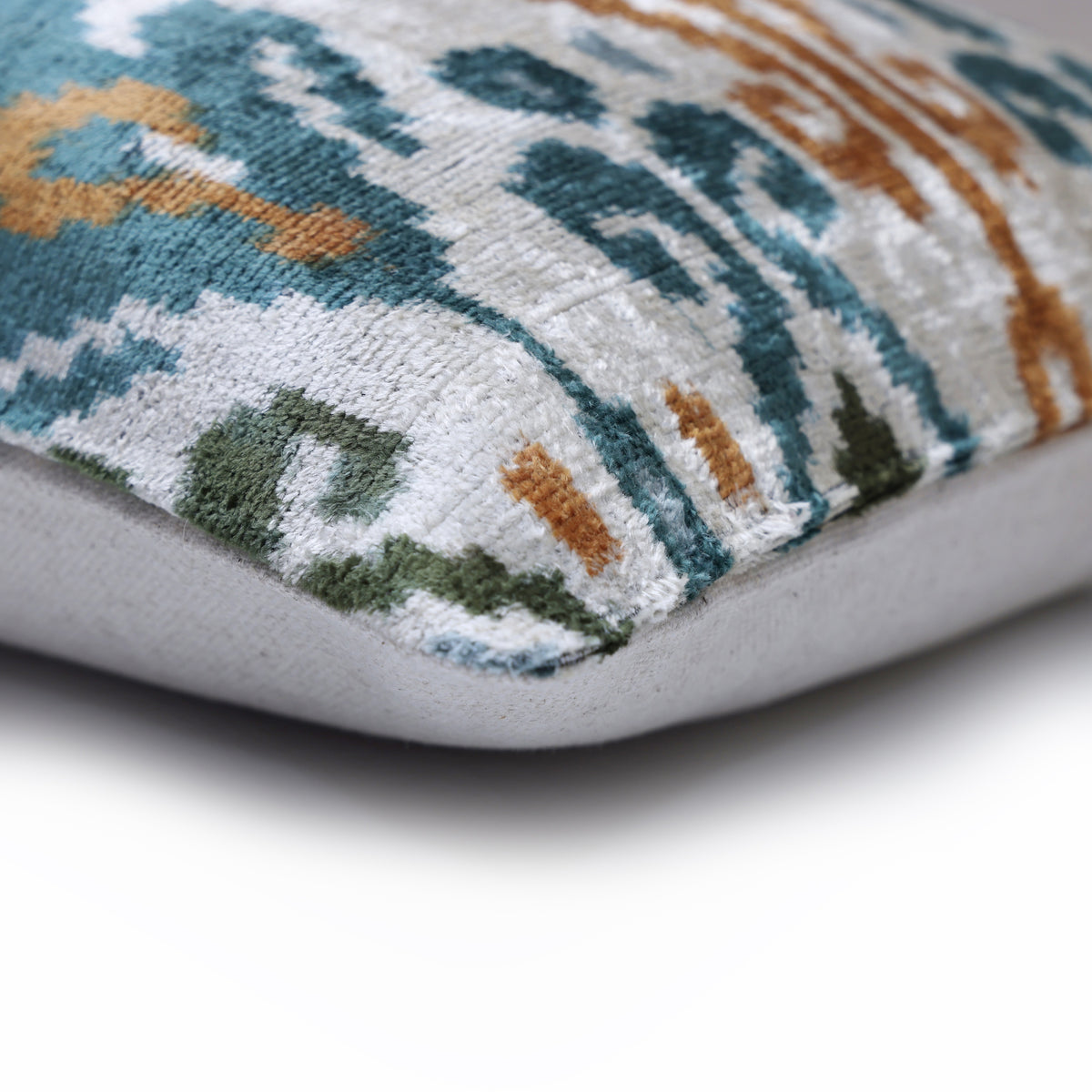 Corner detail of silvery white velvet pile with neutral fabric backing