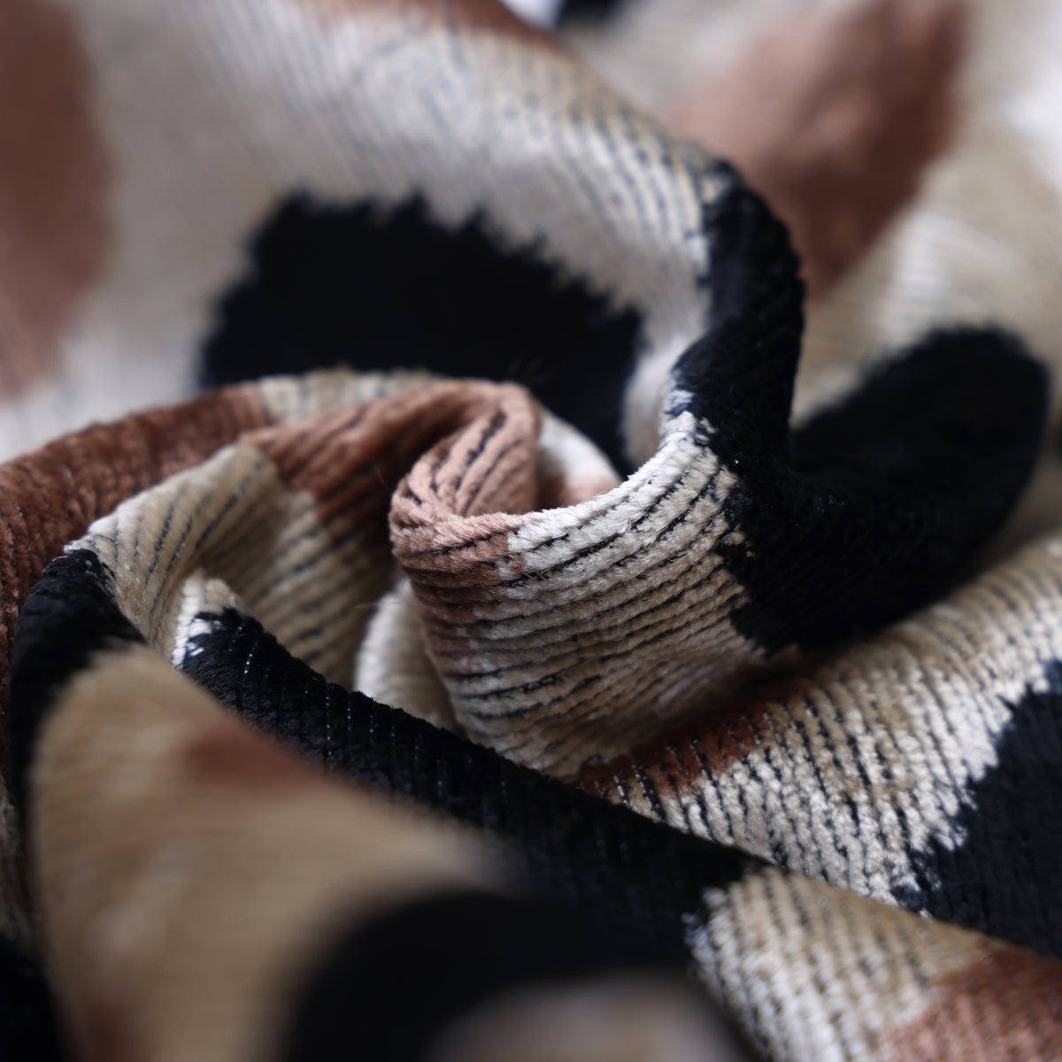 Close-up of silk velvet fold in light champagne beige and dusty blush rose