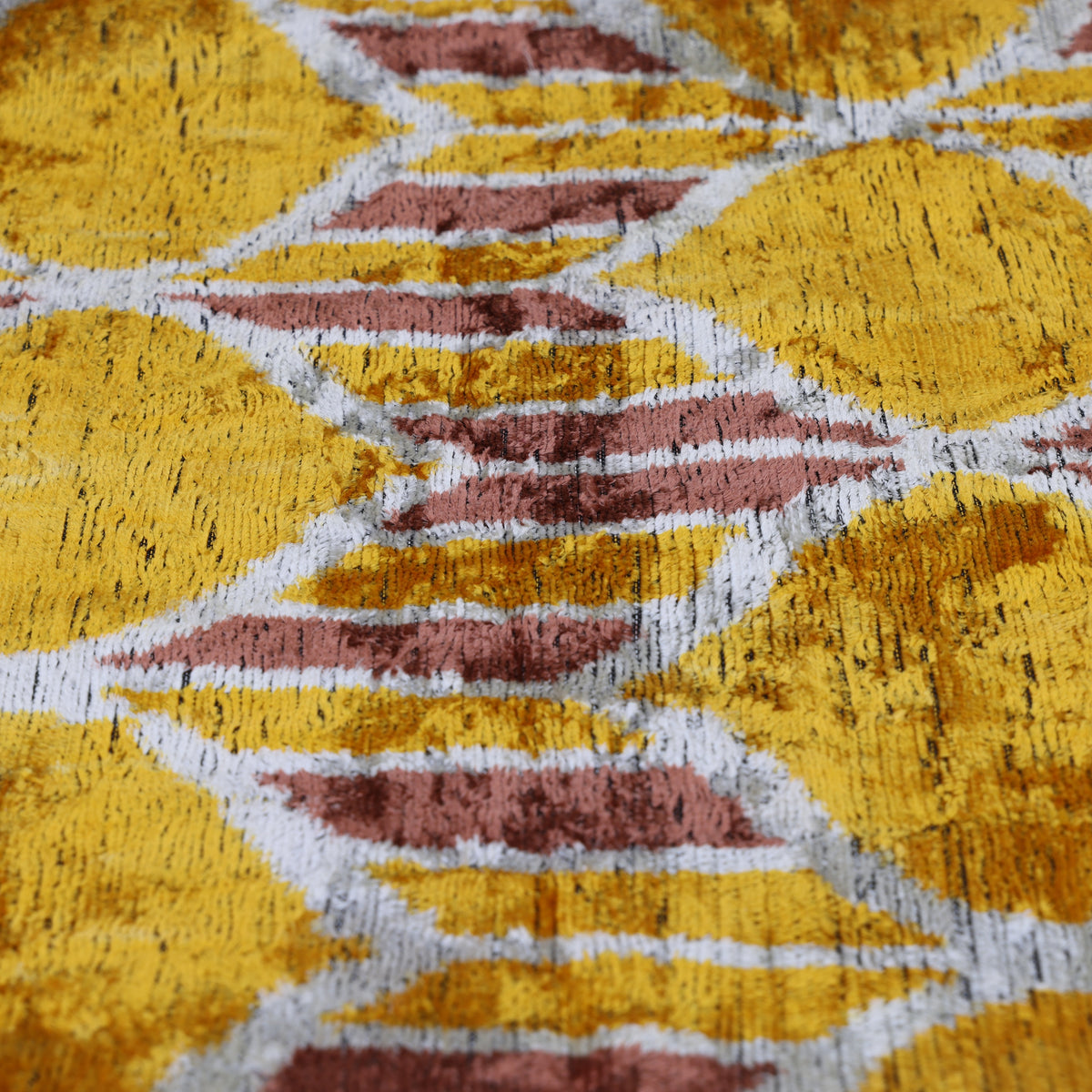 Plush silk velvet pile showing mustard gold geometric diamond pattern