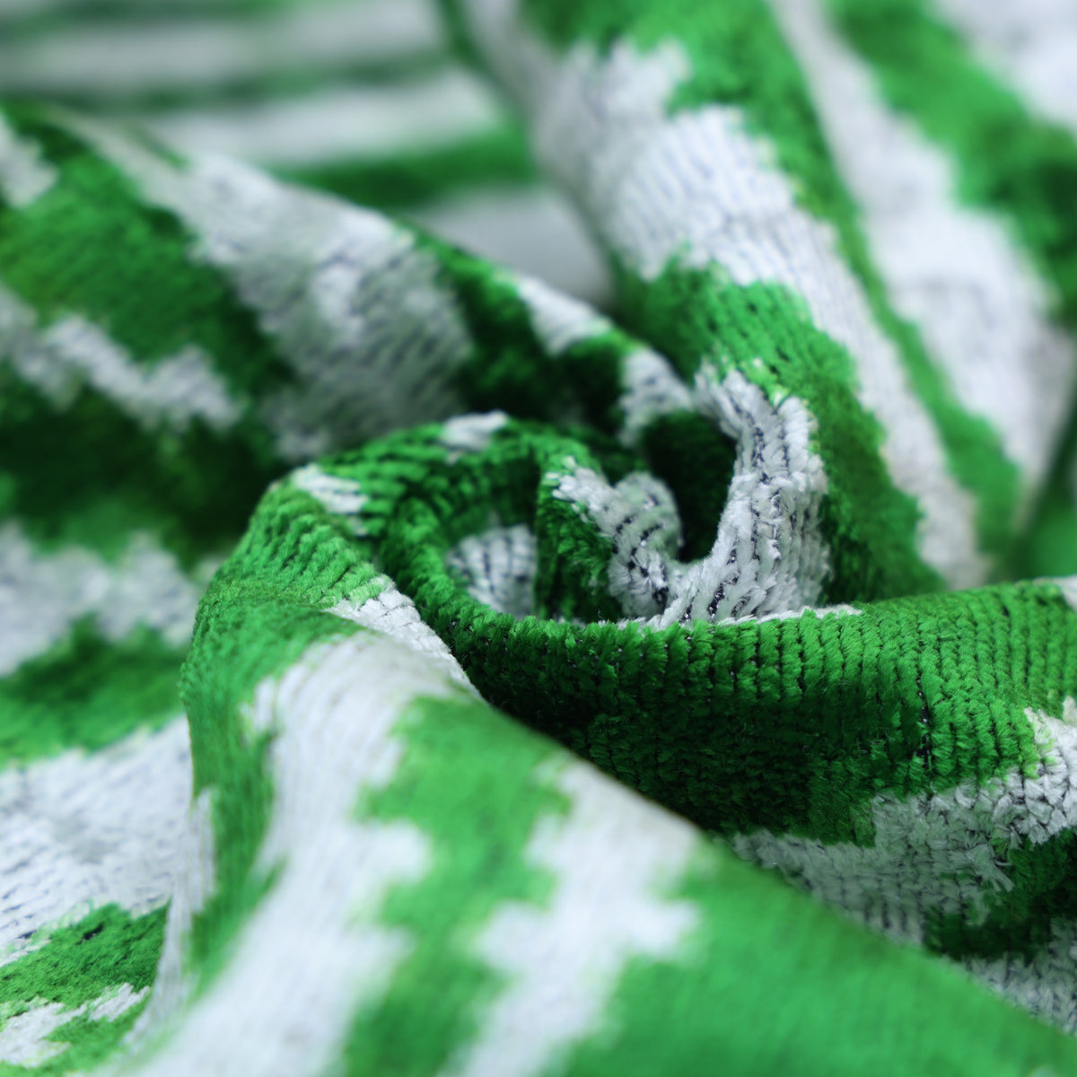 Swirled emerald green and cool white zebra velvet detail showing the fabric's sheen.