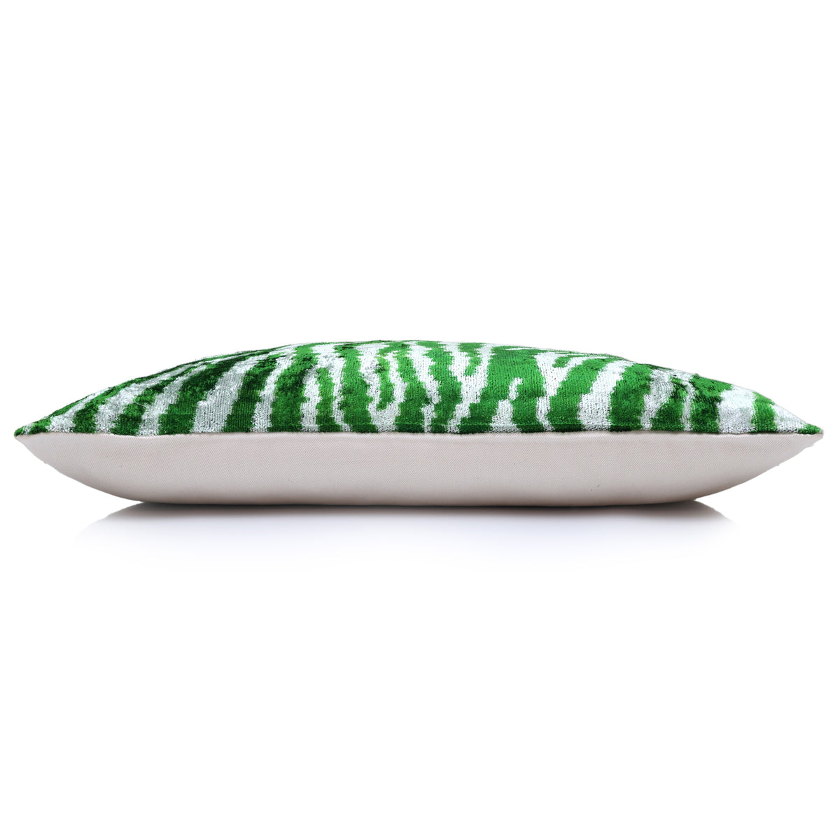 Bottom edge of the emerald green and cool white zebra lumbar pillow with flat profile and backing.