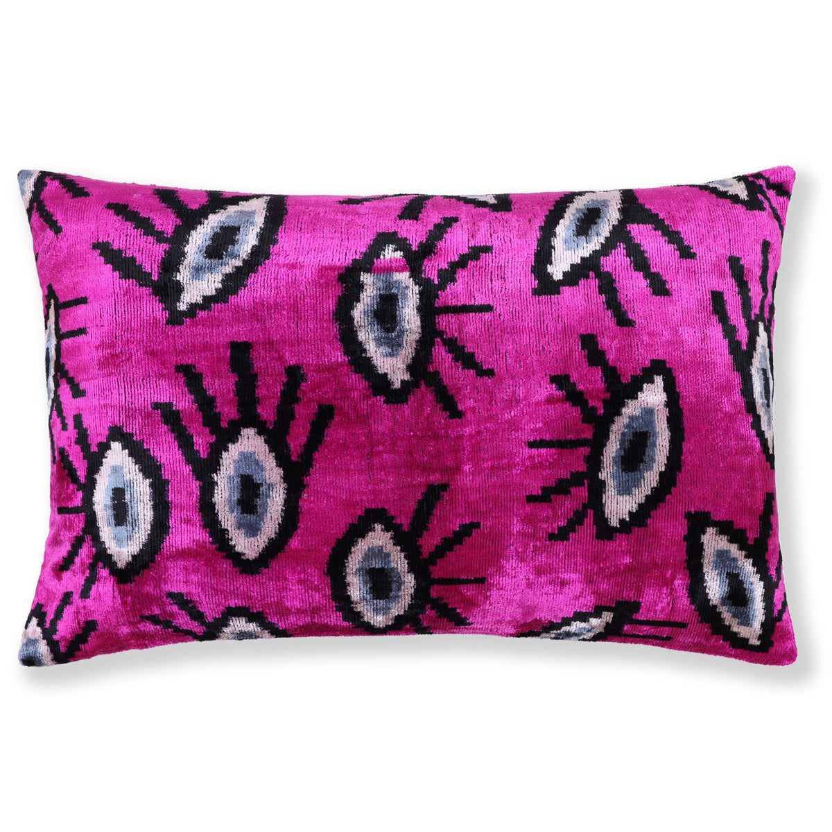 Magenta pink lumbar pillow with black, white, and slate blue-gray evil eye ikat pattern