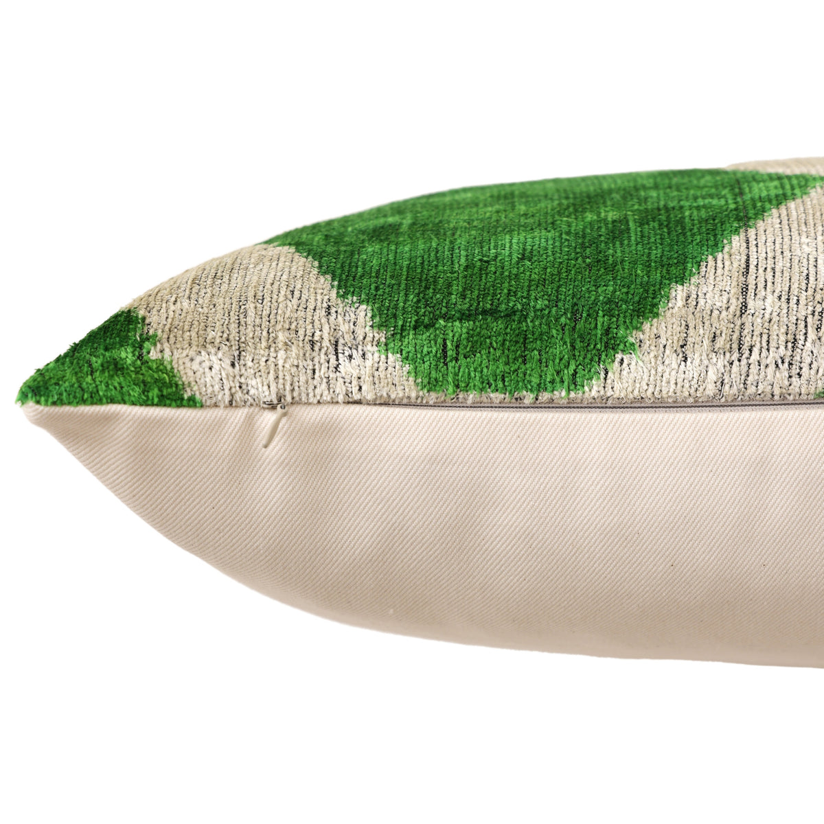Bottom edge close-up showing concealed zipper beneath the emerald green and pale greige velvet