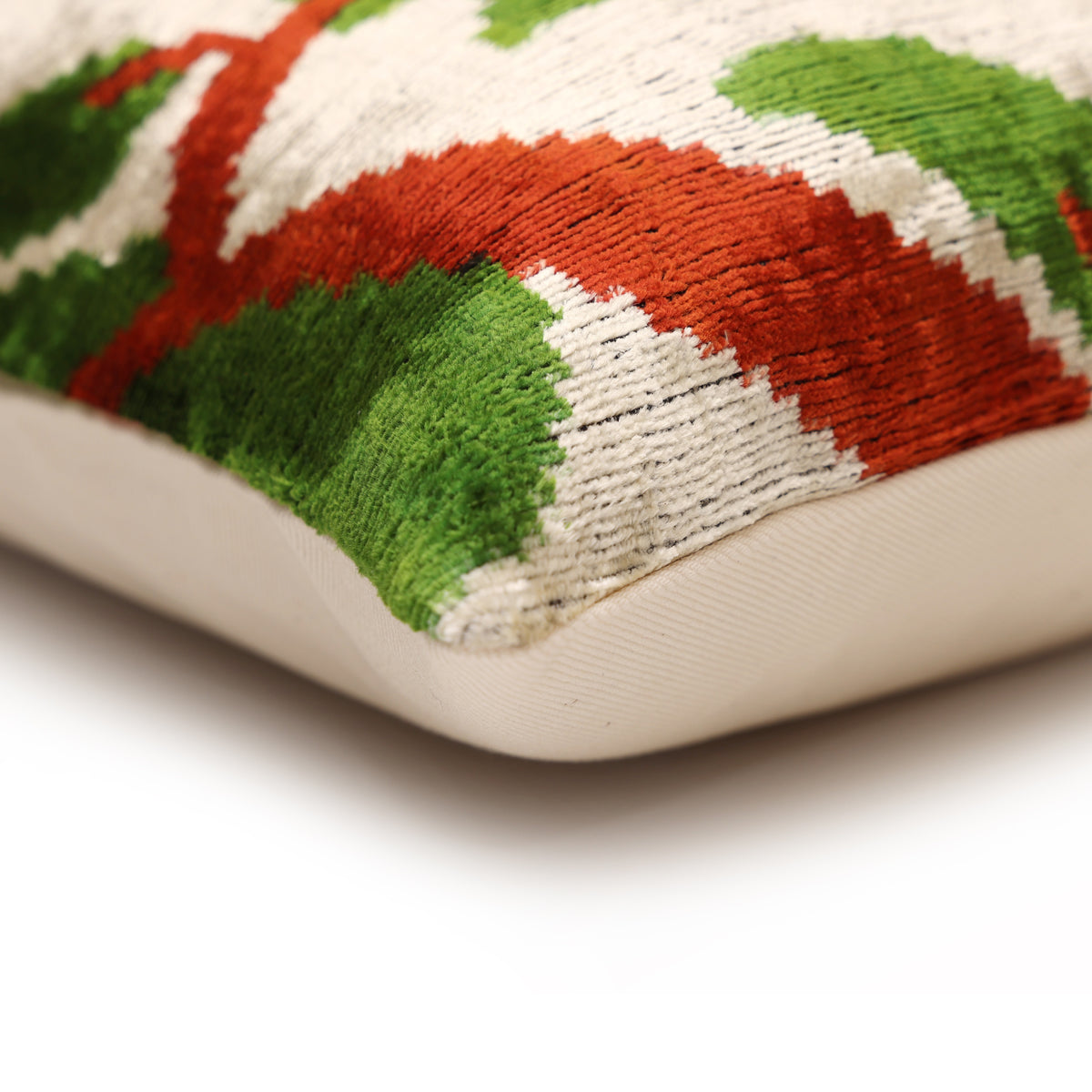 Corner detail of leopard pillow seam with light oatmeal beige velvet front