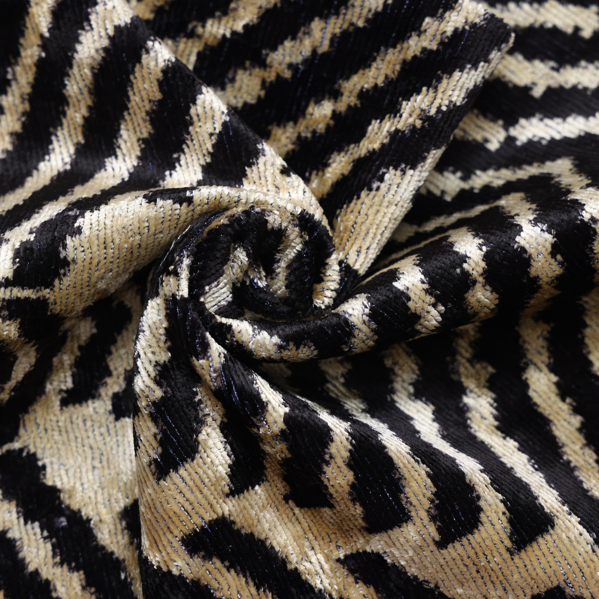Close fabric view showing jet black and champagne beige chevron velvet with ribbed texture