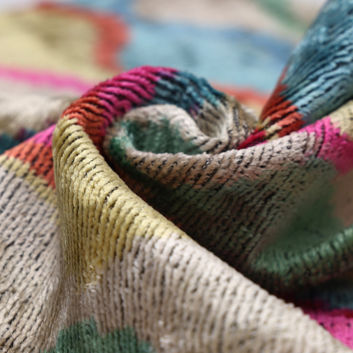 Textured velvet fold in champagne beige with magenta pink and sky blue ikat accents