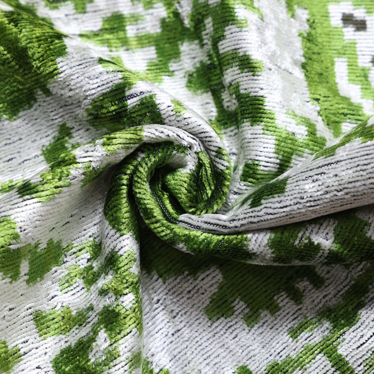 Close view of leaf green and silvery white silk velvet texture and weave