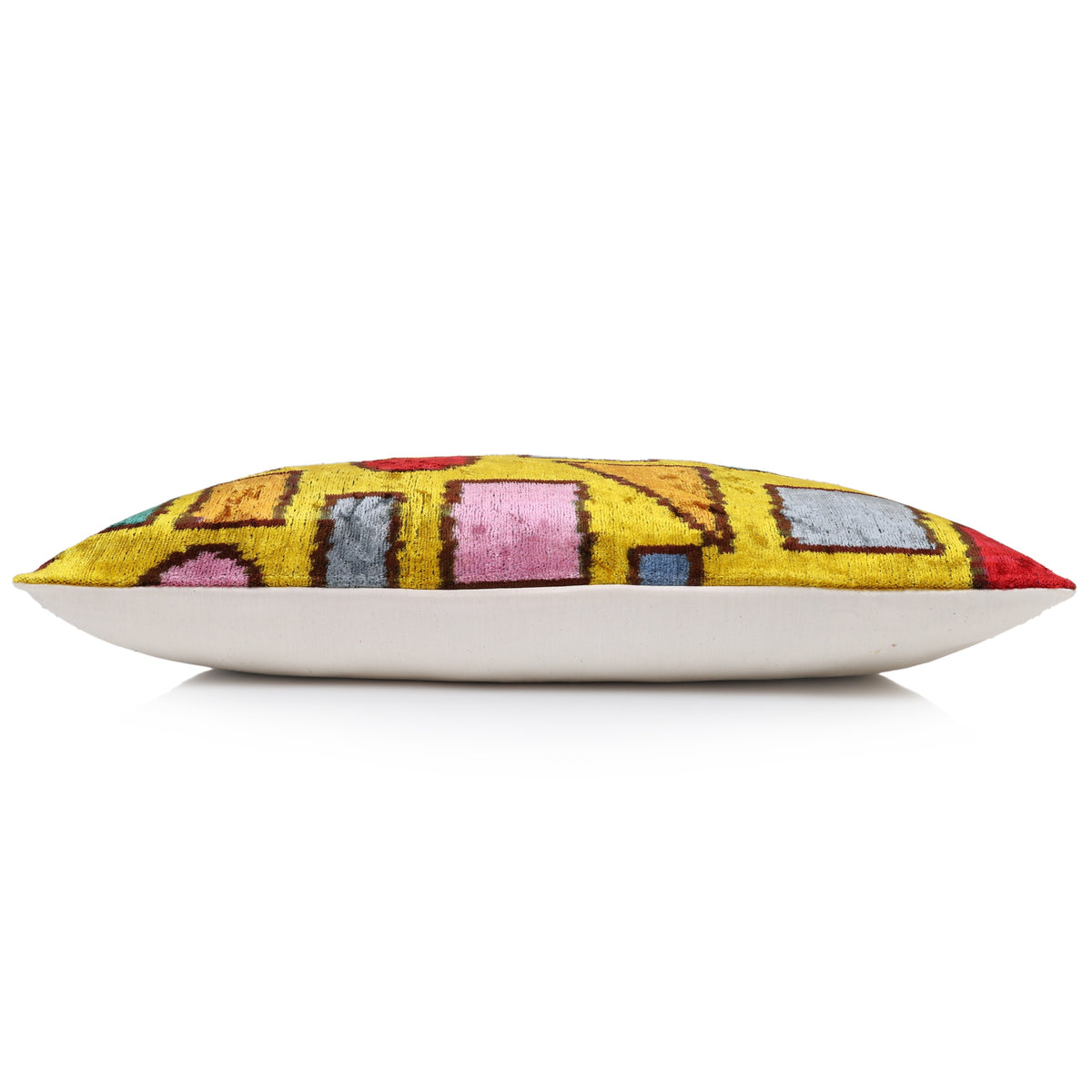 Side profile of mustard geometric lumbar pillow showing depth and white backing