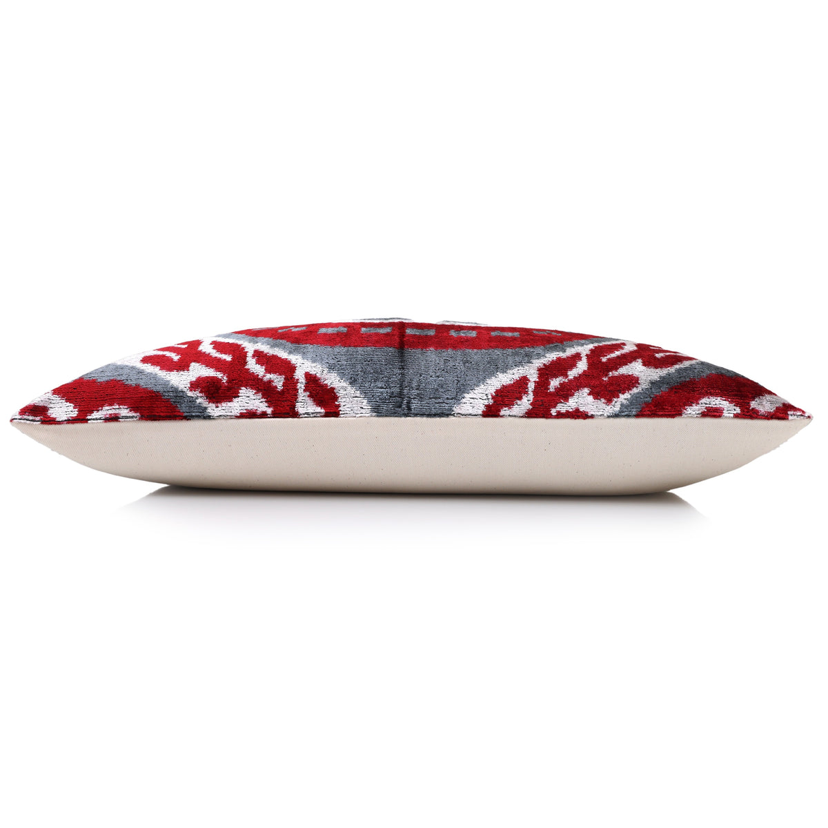 Side profile of the crimson red and slate gray lumbar pillow with solid backing