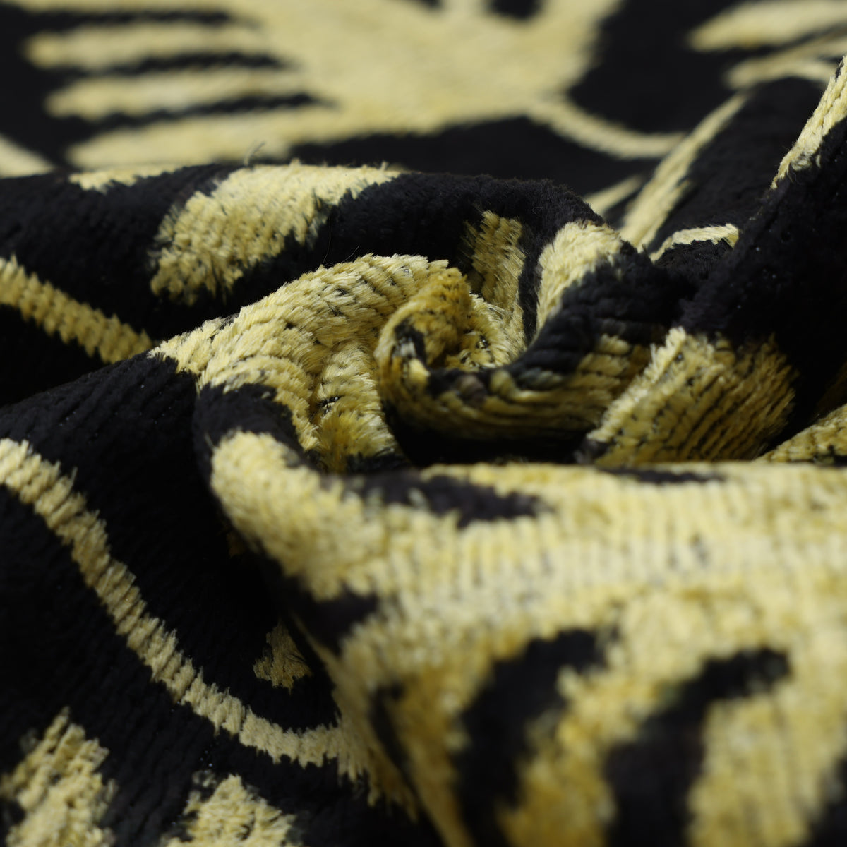 Macro view of chartreuse gold silk velvet with a textured swirling pile