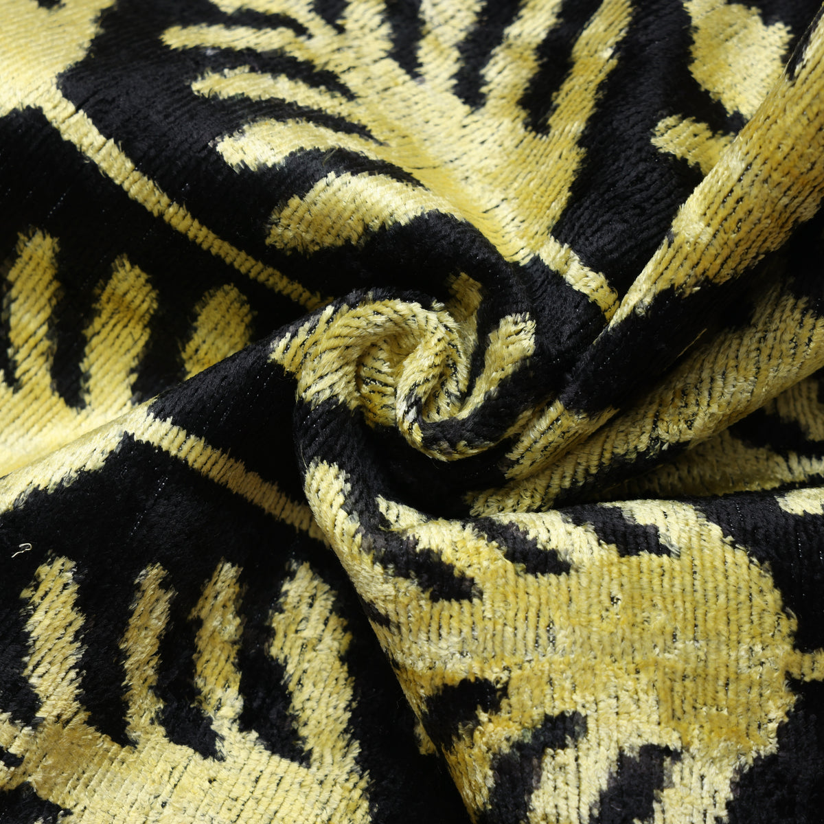Close-up of chartreuse gold velvet showing directional sheen and texture