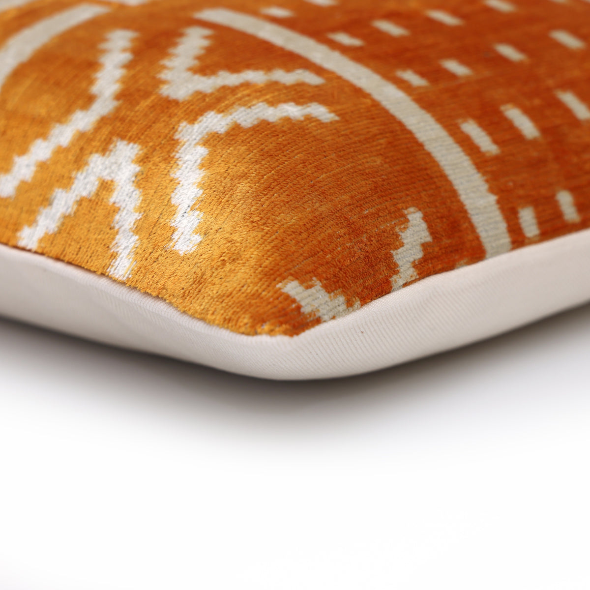 Corner profile of marigold yellow and ivory white lumbar pillow with linen backing