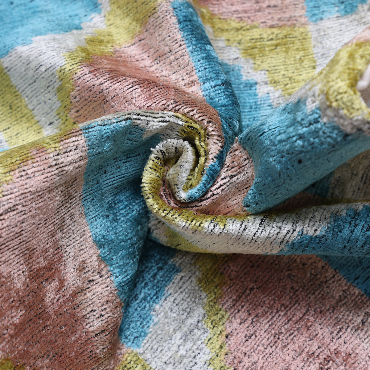 Close-up of folded silk velvet showing the pillow’s plush cut-pile texture