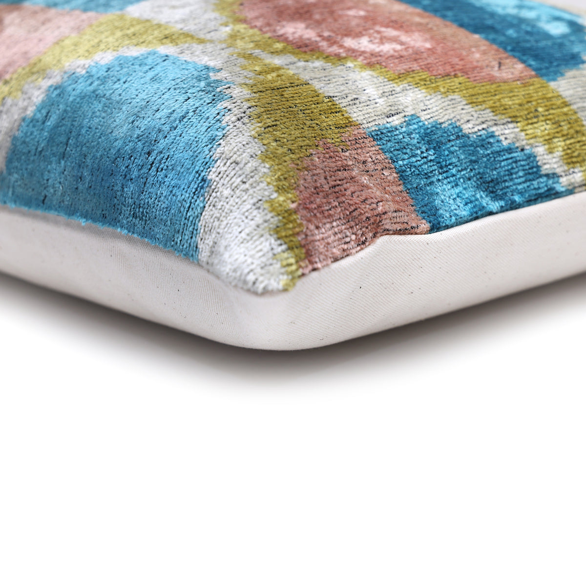 Corner detail of the patterned velvet front meeting the linen backing