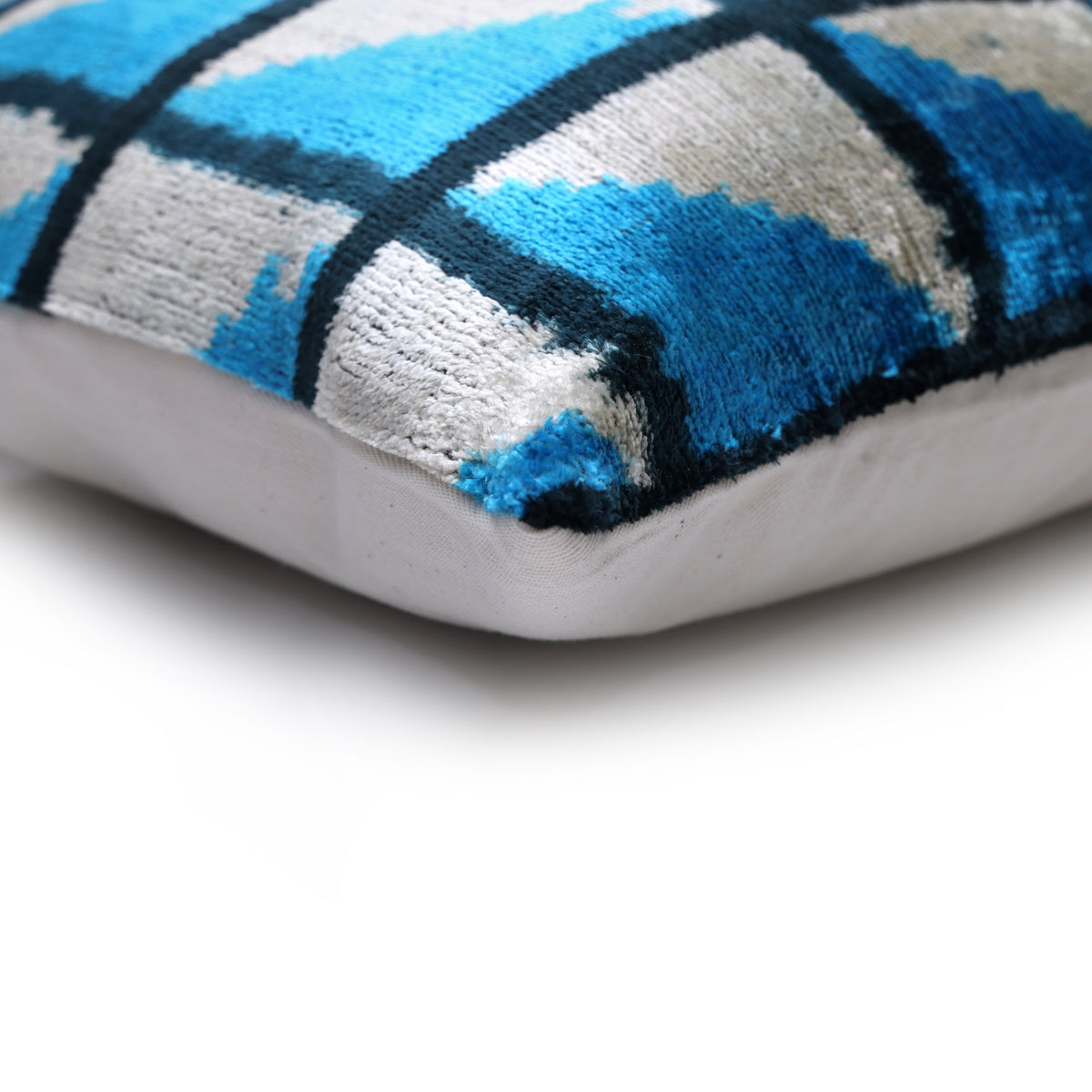 Corner detail of geometric lumbar pillow with seam and linen backing