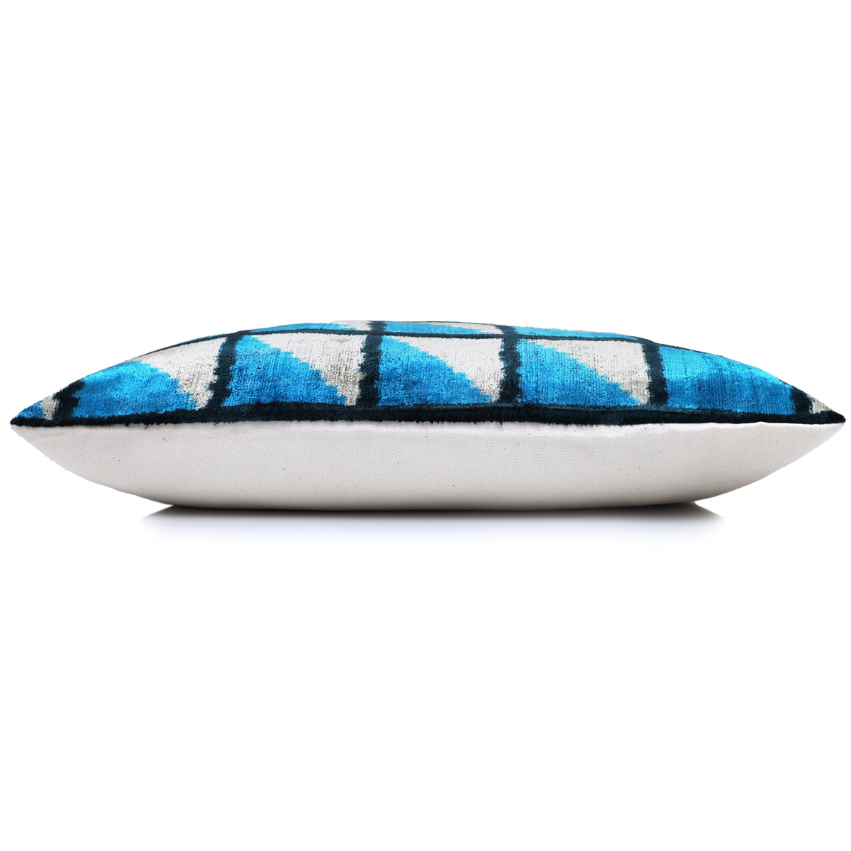 Side profile of cerulean blue lumbar pillow showing depth and linen back