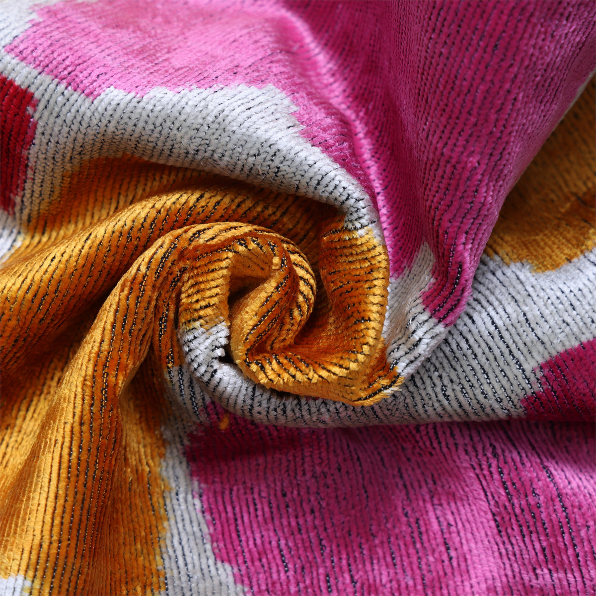 Swirled marigold yellow and fuchsia pink velvet close-up showing changing sheen
