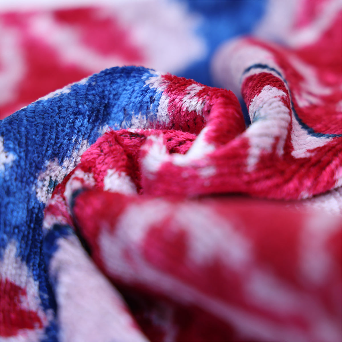 Draped magenta pink velvet showing folds, sheen and ikat pattern