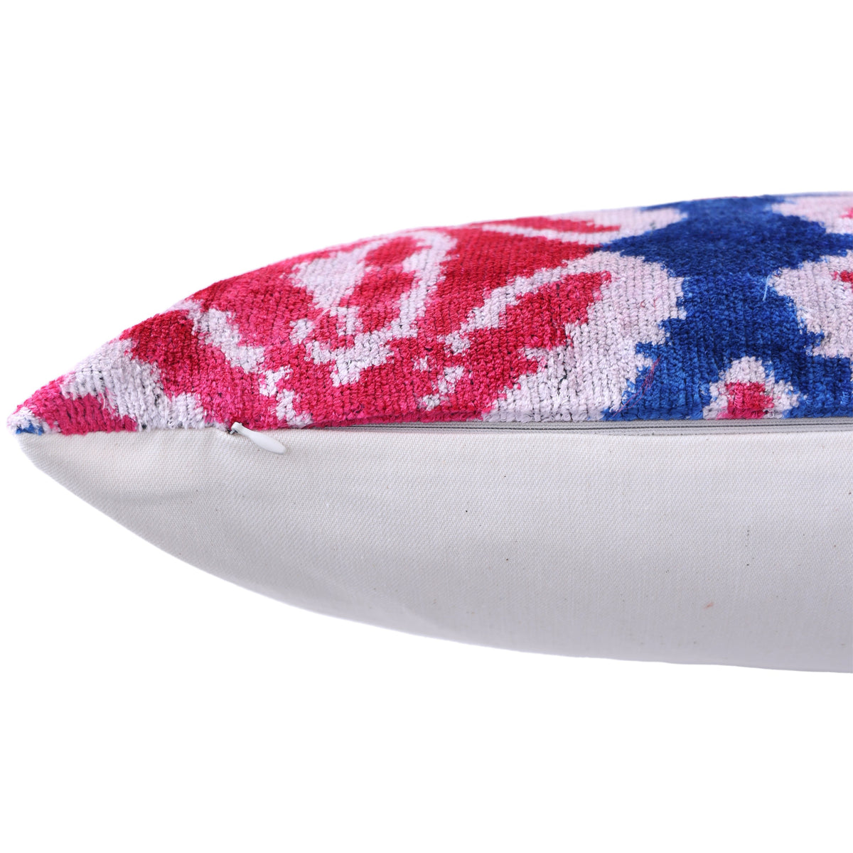 Close-up of hidden zipper along the side seam of magenta pink ikat pillow