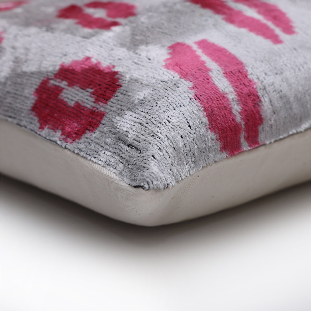 Corner detail of silver gray velvet seam with plain linen backing
