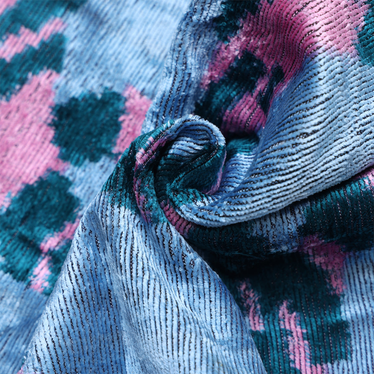 Close-up of ice blue silk velvet showing ribbed cut-pile texture and sheen