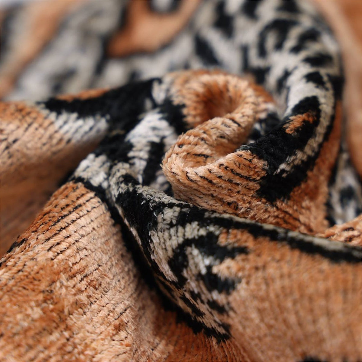 Macro view of camel silk velvet weave with black tiger pattern detail