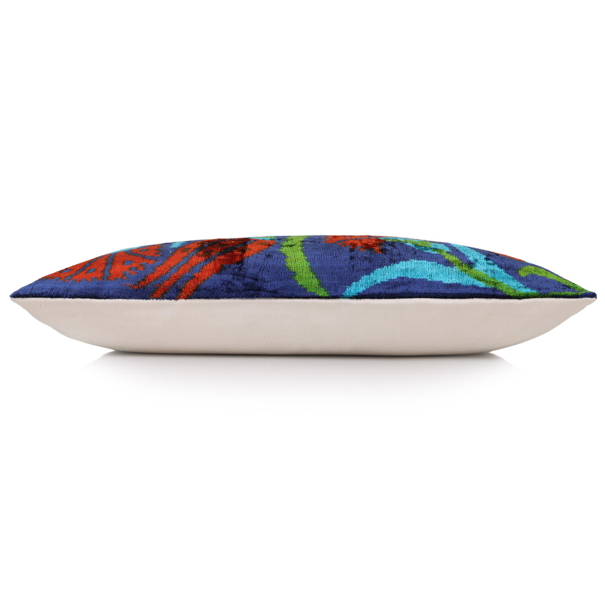 Edge profile of floral lumbar pillow showing plush velvet depth and contrasting linen back