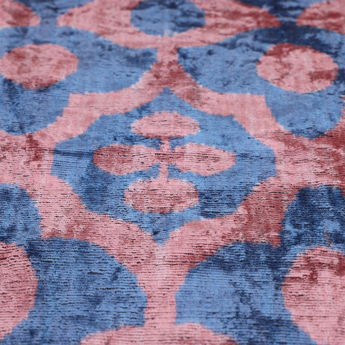 Angled view of the slate blue and dusty rose pink velvet face and medallion