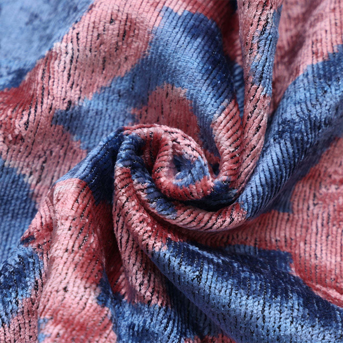 Close-up of slate blue and dusty rose pink gathered velvet texture