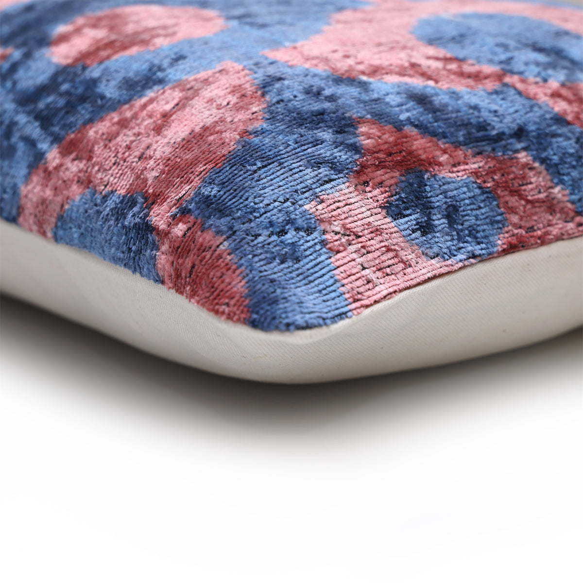Corner view showing slate blue and dusty rose pink velvet front with plain back
