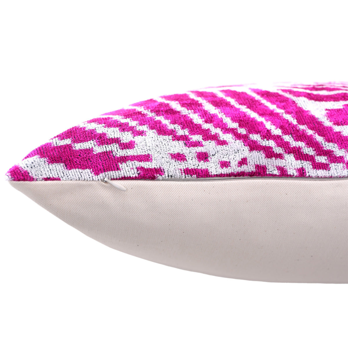 Close-up edge of magenta pink and crisp white lumbar pillow showing hidden zipper on backing