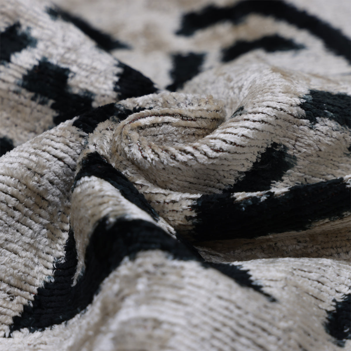 Folded ivory silk velvet showing directional sheen and textured pile