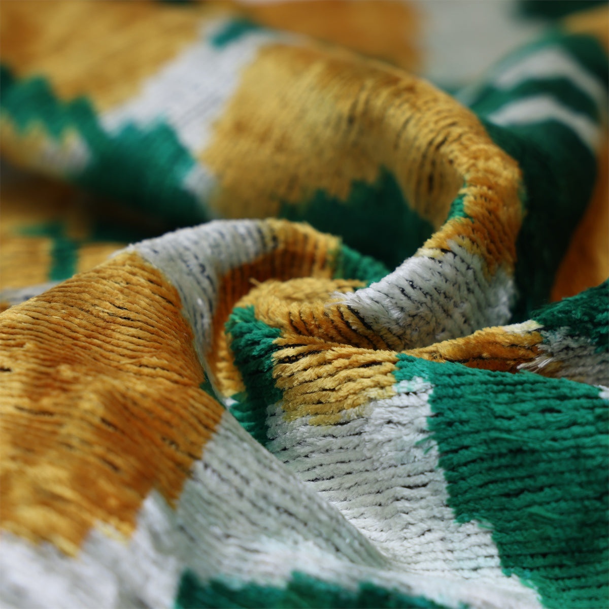 Swirled velvet surface showing silvery white, green and gold sheen