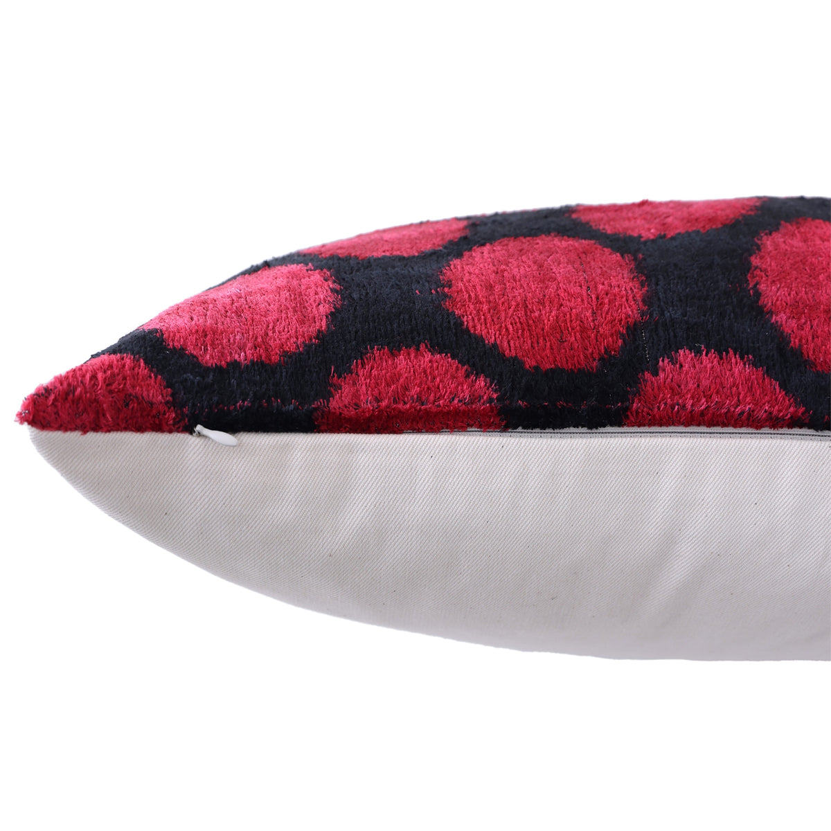 Close-up of side seam and hidden zipper on crimson red and black pillow