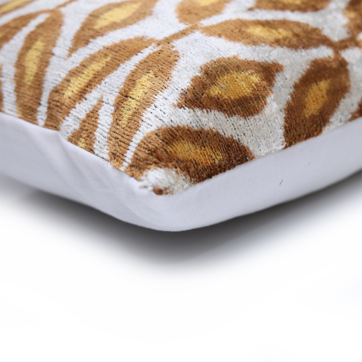 Close-up of lumbar pillow corner with silvery white velvet construction