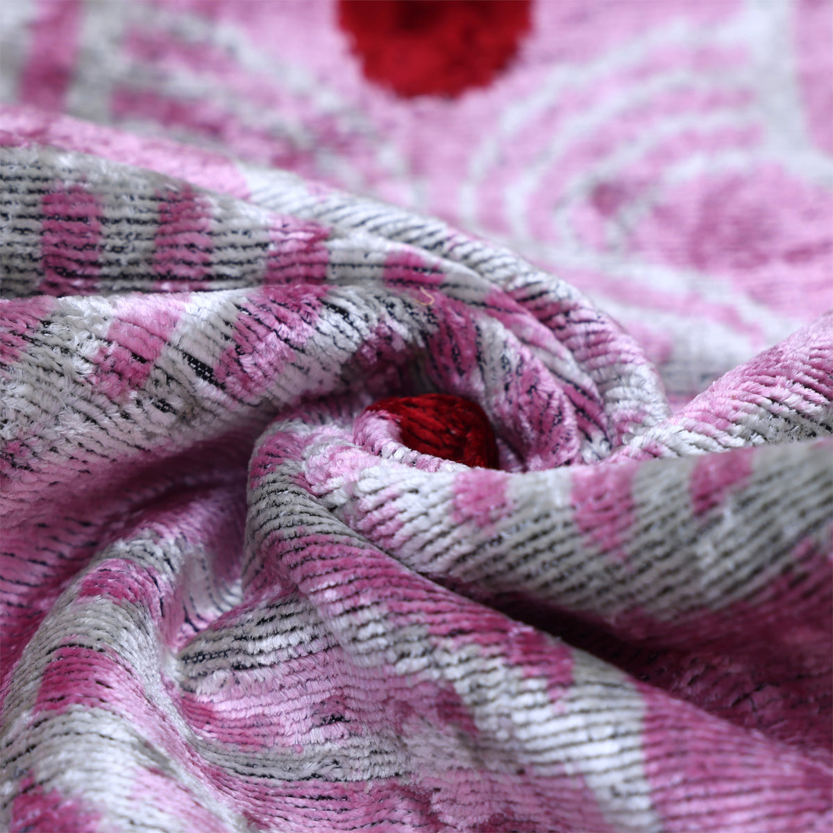 Tight swirl close-up highlighting the sheen and weave of lavender pink velvet